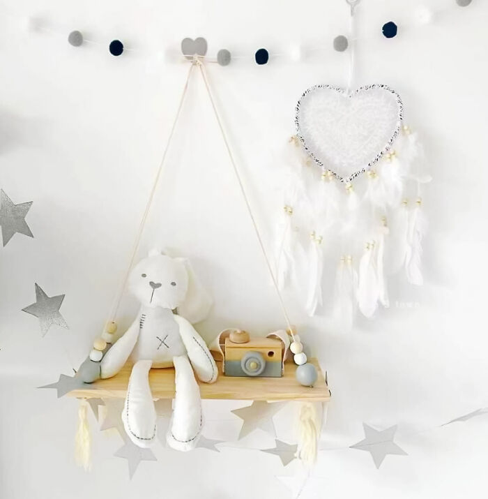 Hanging swing with white bunny toy on it