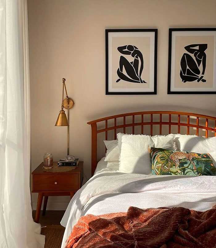 A matching set of wall art hanging on bedroom wall