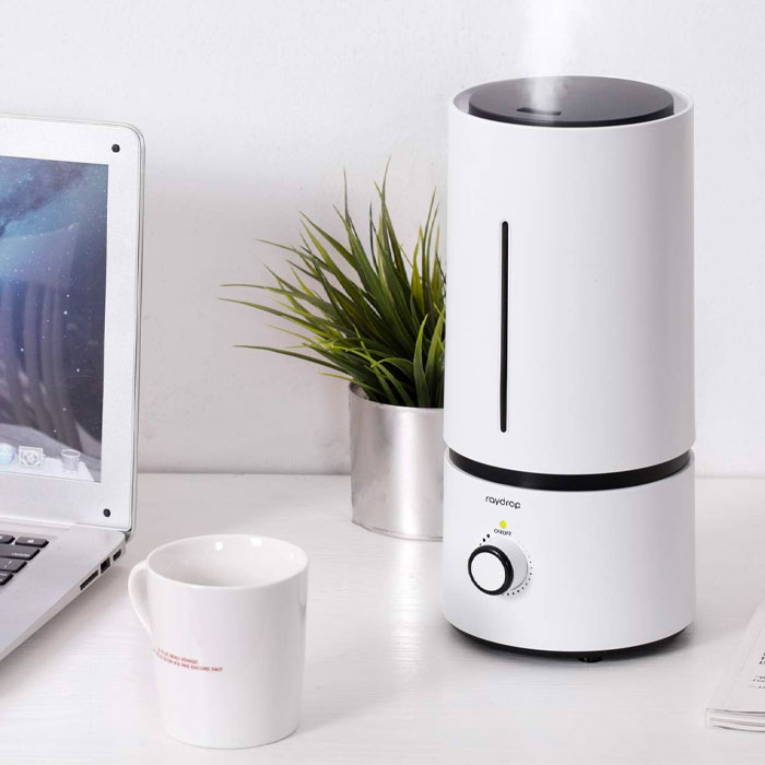 Humidifier near the cup and the pot with grass