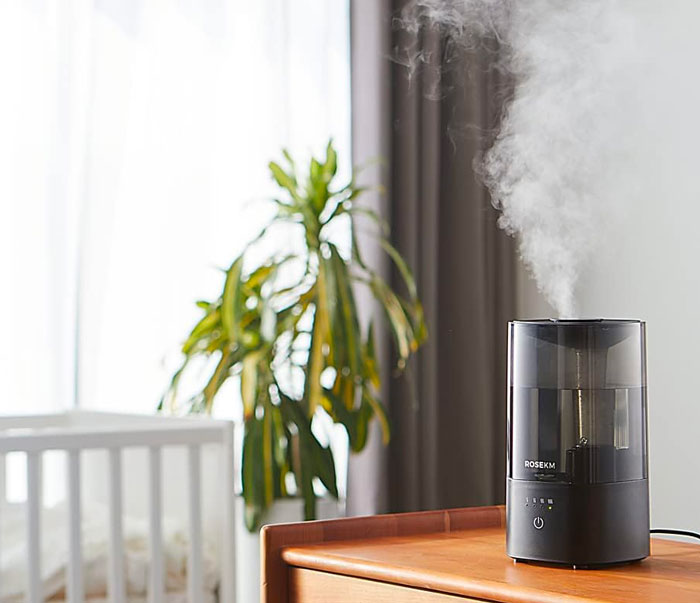Humidifier on the dresser near the baby bed