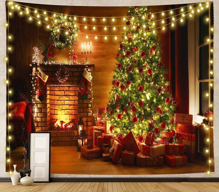Green Christmas tree decorated with red ornaments and lights near a cozy fireplace with affordable Christmas decor ideas.