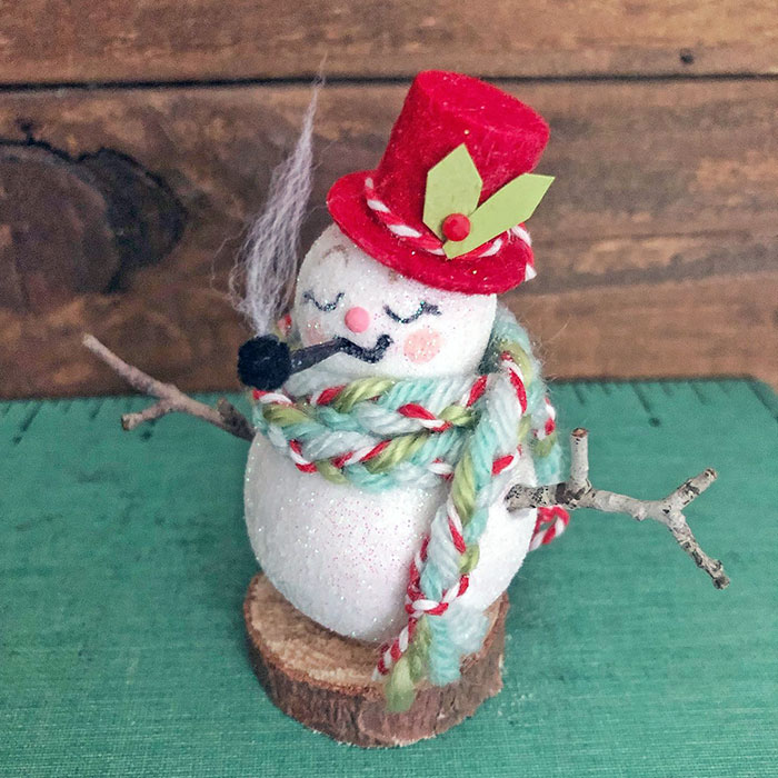 I Started With A Plain Spun Cotton Snowman's Body, Painted His Face, And Glittered Him. His Hat Was Black Plastic But I Flocked It Red