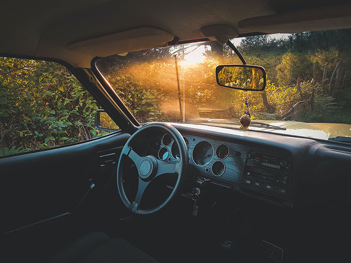Car’s windshield with a steering wheel Car’s windshield with a steering wheel