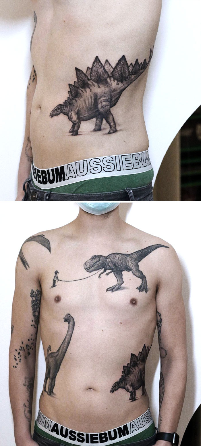 Cool dinosaur tattoos on the waist and chest, featuring a detailed Stegosaurus and a T-Rex in creative designs.