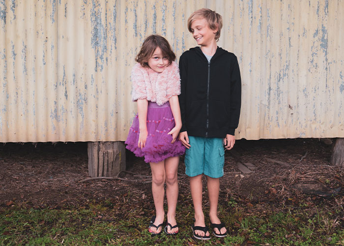 Two children standing outdoors, illustrating outdated parenting myths about kids and childhood behavior.