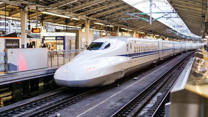 High-speed bullet train at a busy station, showcasing advanced transportation as part of positive world moments shared online.