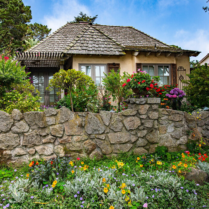 House with flowers and trees in front yard