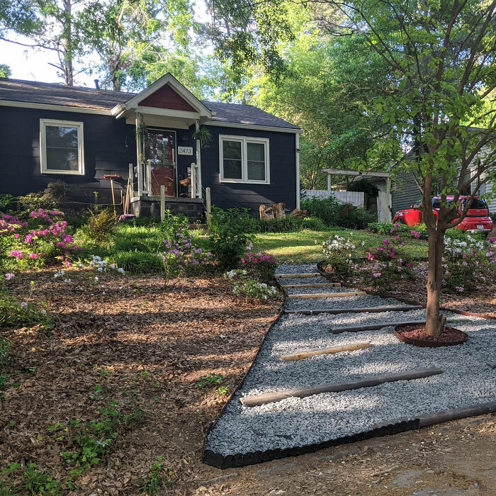 House with front yard with flowers and trees