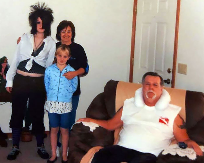 Family posing awkwardly in living room, capturing a hilarious moment.