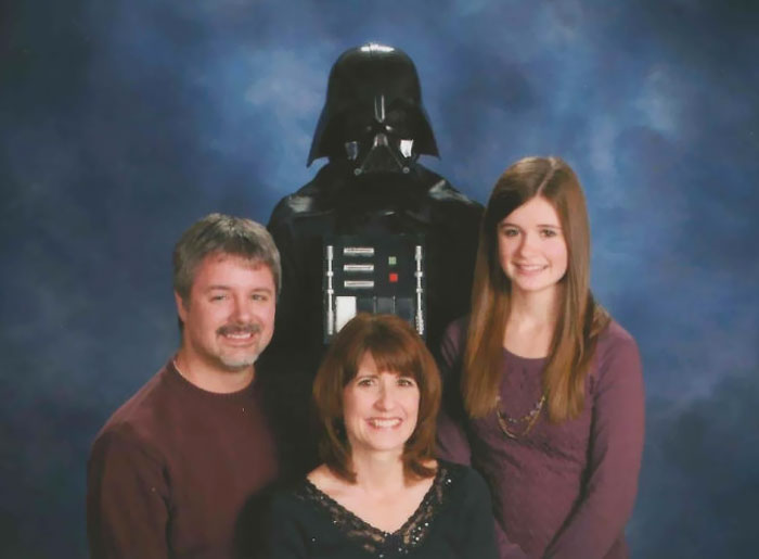 Family photo with Darth Vader, creating a humorous and embarrassing yet memorable moment.