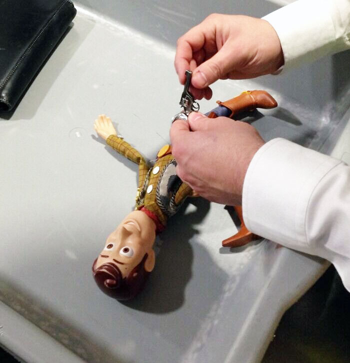 I Have Traveled The World With Toy Story's Woody Taking Pictures For My Son. At Heathrow Airport, Security Just Confiscated His Weapon, Keep The World Safe Boys
