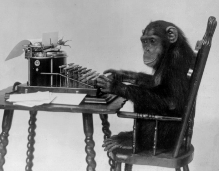Chimpanzee using a typewriter, illustrating intriguing facts not learned in school.