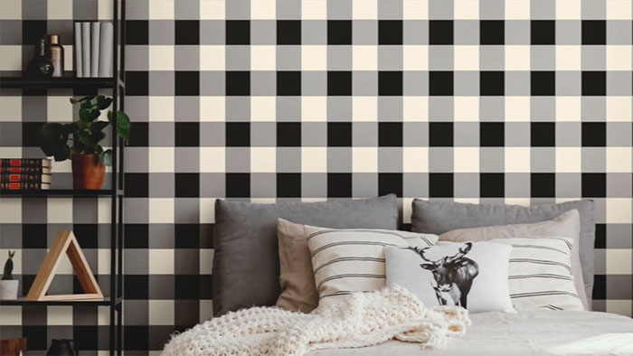 Checkers wall painting design in a bedroom with neutral tones and cozy textured bedding for modern decor inspiration.