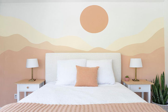 Sunset wall painting design in bedroom with soft earth tones, minimalist style, and cozy white bed setup for peaceful ambiance