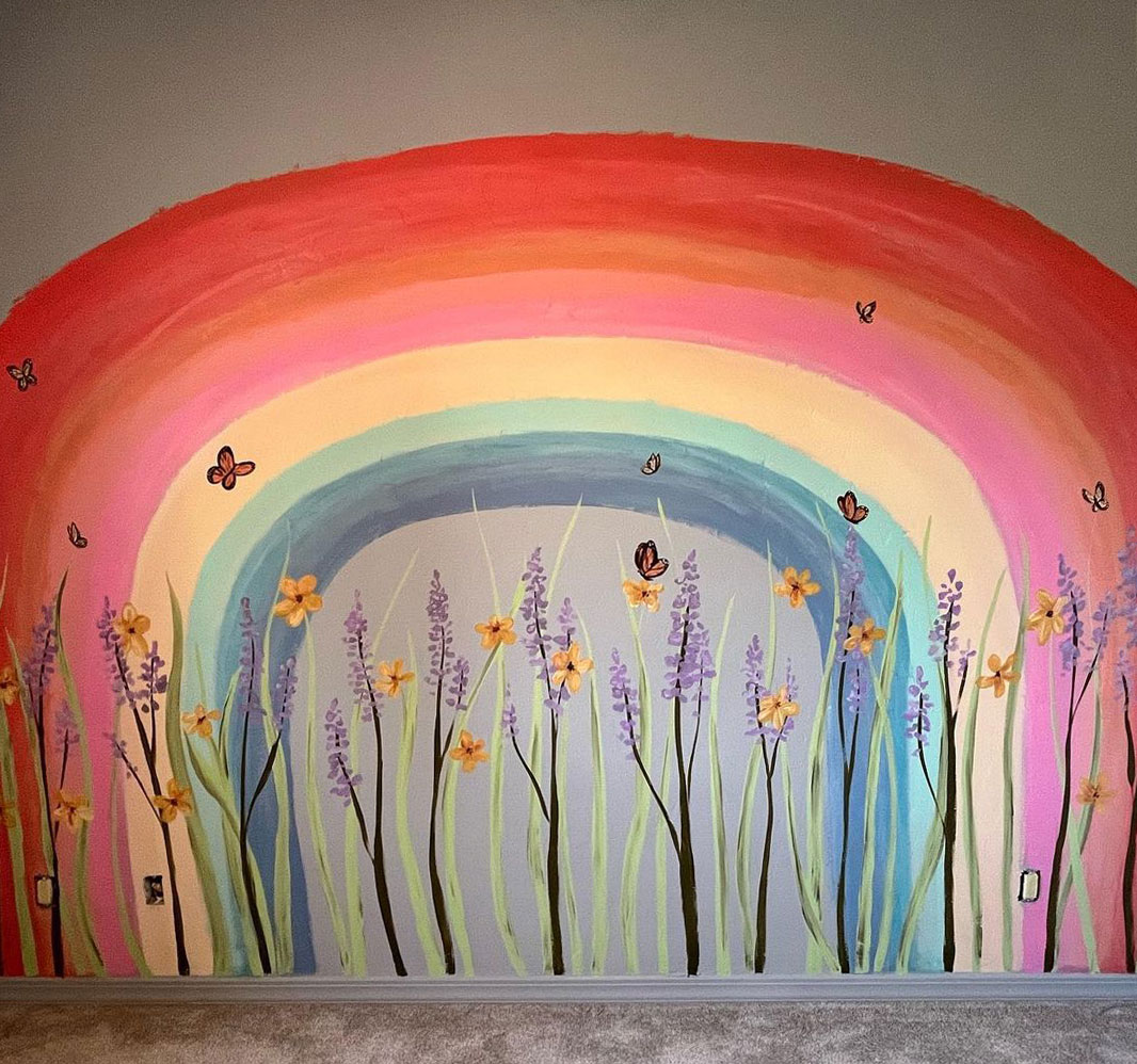 Rainbow wall painting design featuring colorful flowers and butterflies on a gray background for vibrant room decor.