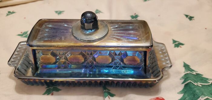 Vintage iridescent glass butter dish found at a flea market, showcasing unique thrift store luck and charm.