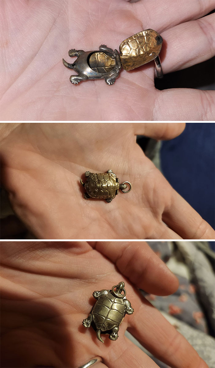 Small vintage turtle charm with a hinged shell held in a person's hand, a unique thrift store find.