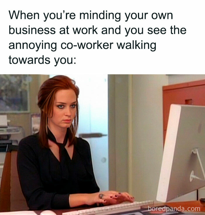 Woman at desk with a frustrated look, illustrating a funny work meme about annoying coworkers.
