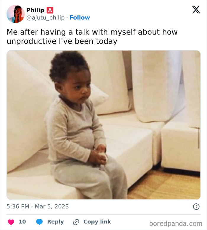 A baby sitting on a couch, looking serious, adding humor to the WFH meme about feeling unproductive during the workday.