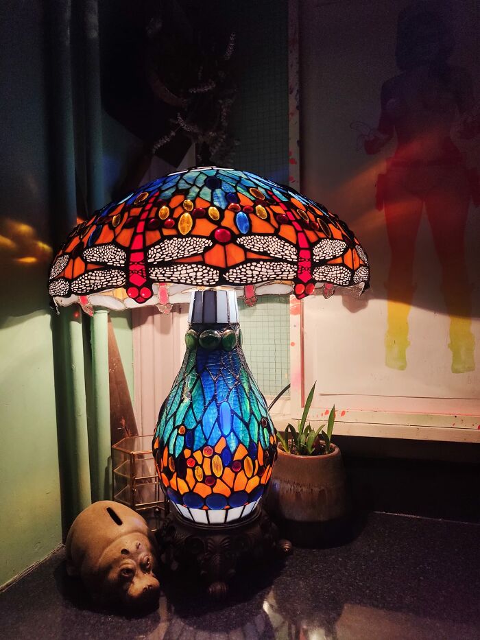Colorful stained glass lamp with dragonfly design found at a thrift store, showcasing unique vintage decor and luck discoveries.