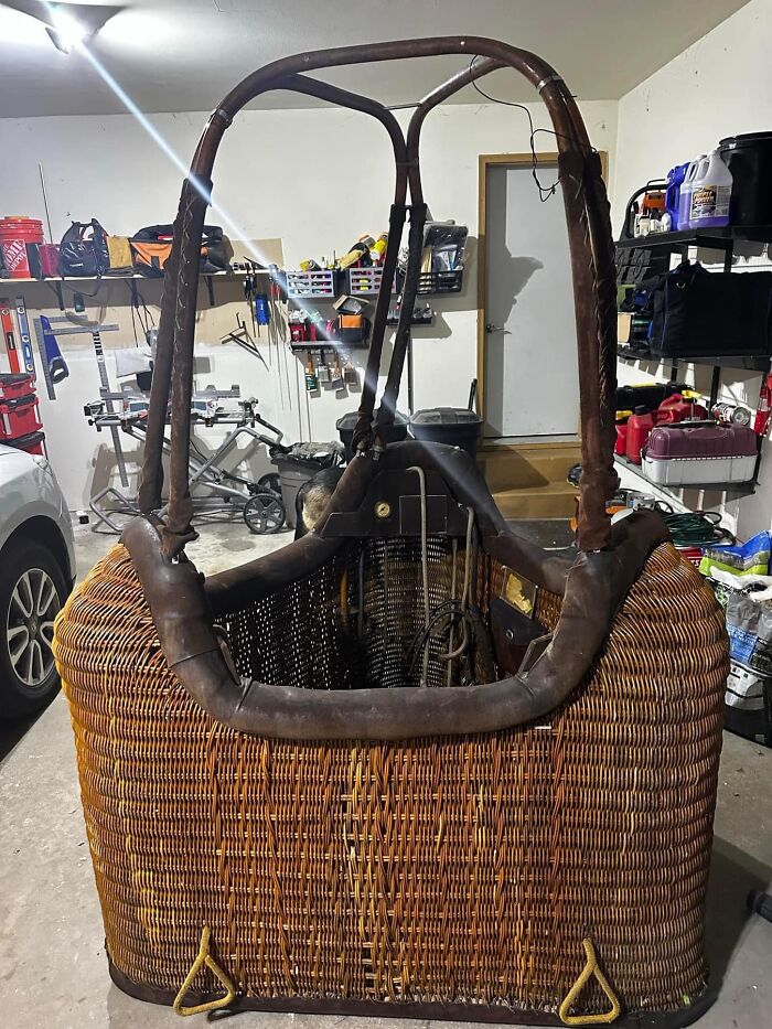 Large vintage wicker hot air balloon basket found in garage, showcasing unique thrift store and flea market luck discovery.