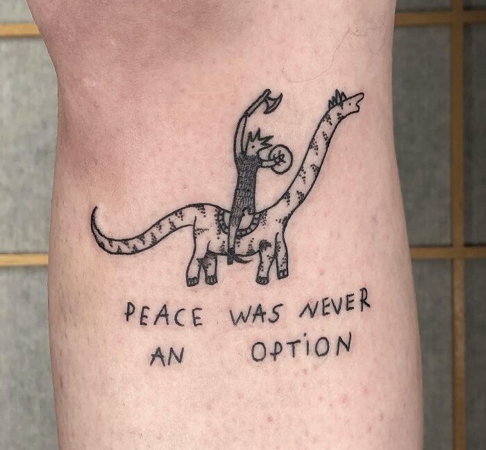 Cool dinosaur tattoo with a rider, featuring the text "Peace was never an option."
