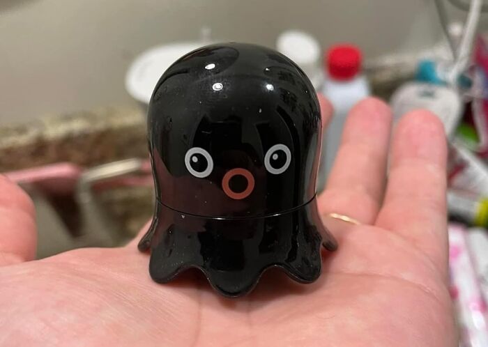 Black octopus-shaped life hack tool resting on a hand, demonstrating practical life hacks for everyday use.