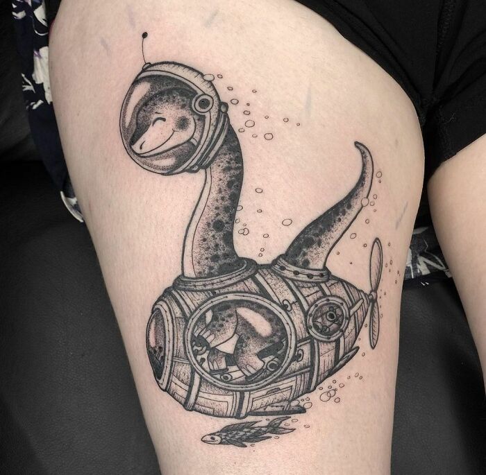Creative dinosaur tattoo design featuring a dinosaur in a submarine, showcasing a cool and imaginative concept.