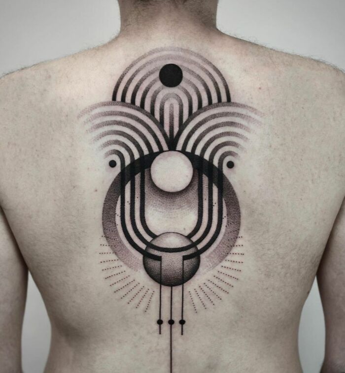 Geometric spine tattoo with abstract patterns and circles, showcasing beautiful tattoo artistry.