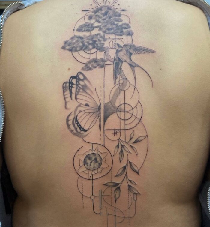 Beautiful spine tattoo featuring a hummingbird, butterfly, geometric shapes, and leaves.