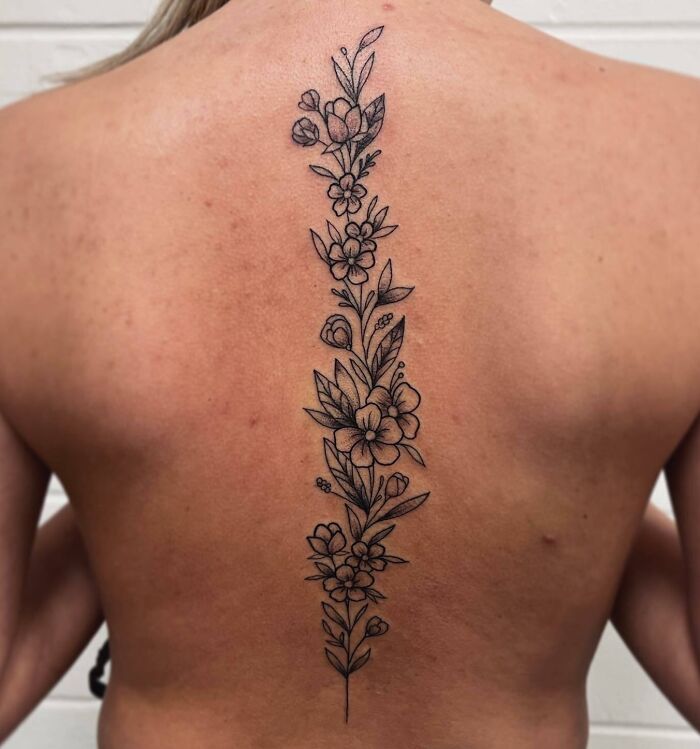 Floral spine tattoo design showcasing intricate and beautiful artwork.