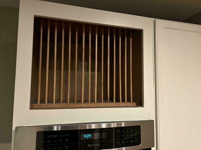 Wooden slatted cabinet above a kitchen oven, an example of mysterious objects people stumble upon.