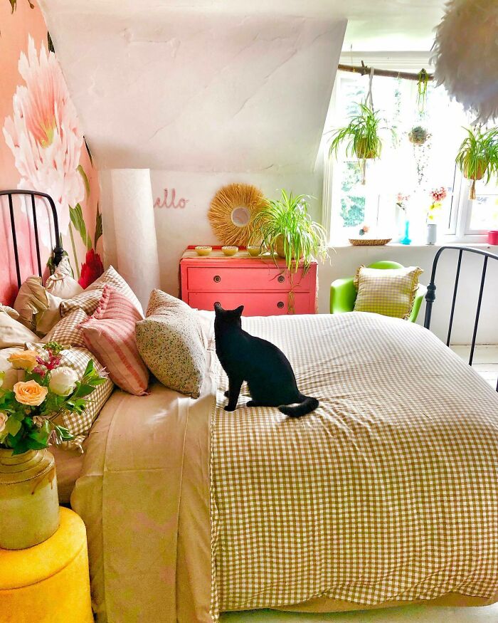 Yellow and white gingham pattern blanket with cat on it