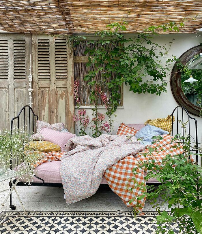 Orange gingham blanket with bed outside