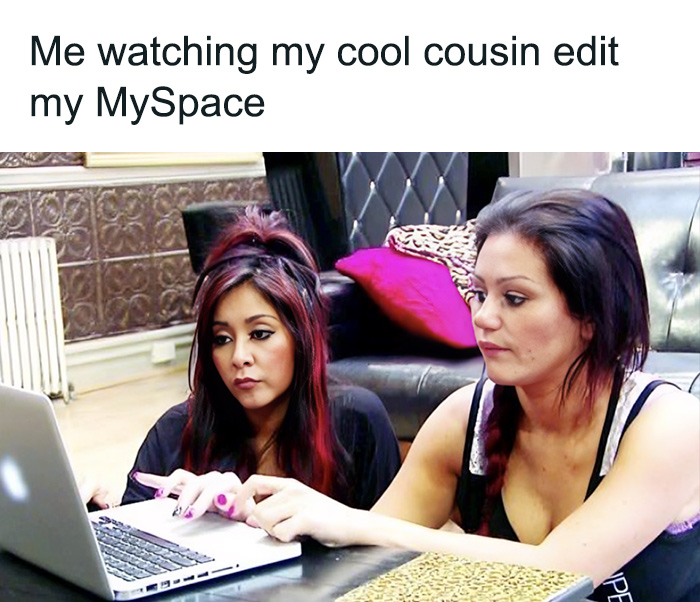 Two women using a laptop, reminiscent of 2000s MySpace era nostalgia.