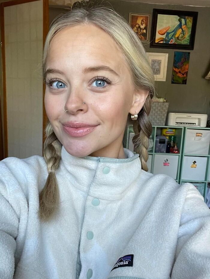 Woman smiling indoors, wearing a light fleece jacket, suitable for Galentine's Day gift inspiration.