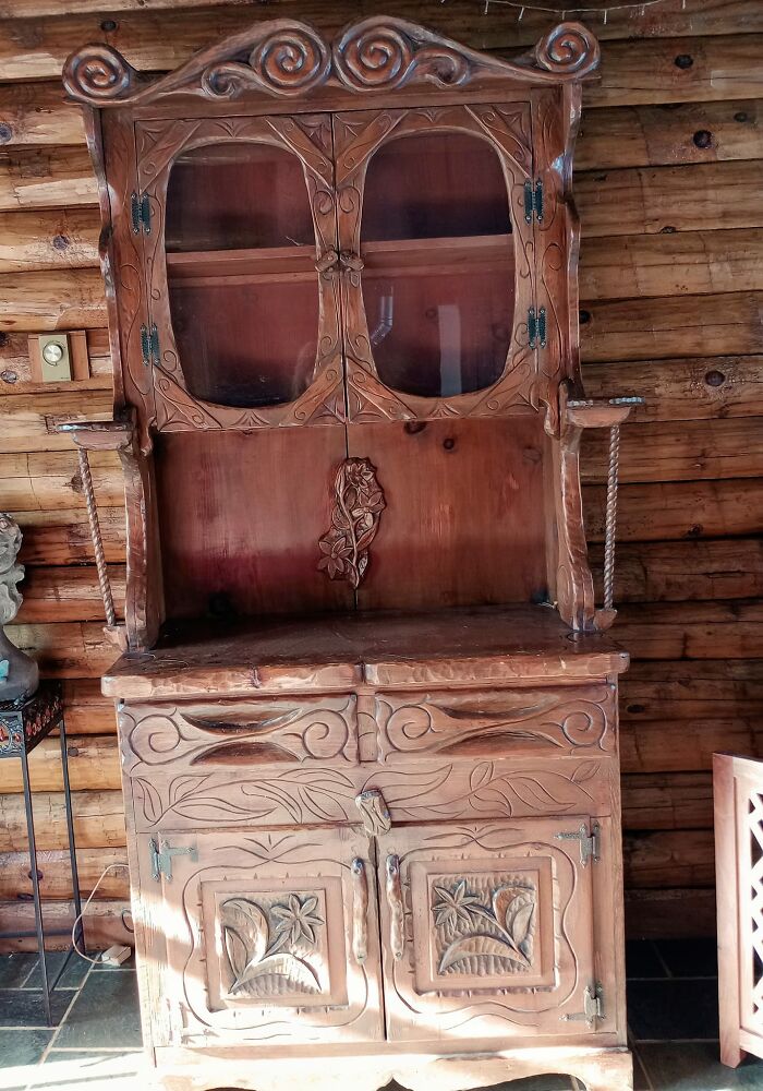 Hand-carved wooden cabinet with floral designs, showcasing unique thrift store and flea market luck find.