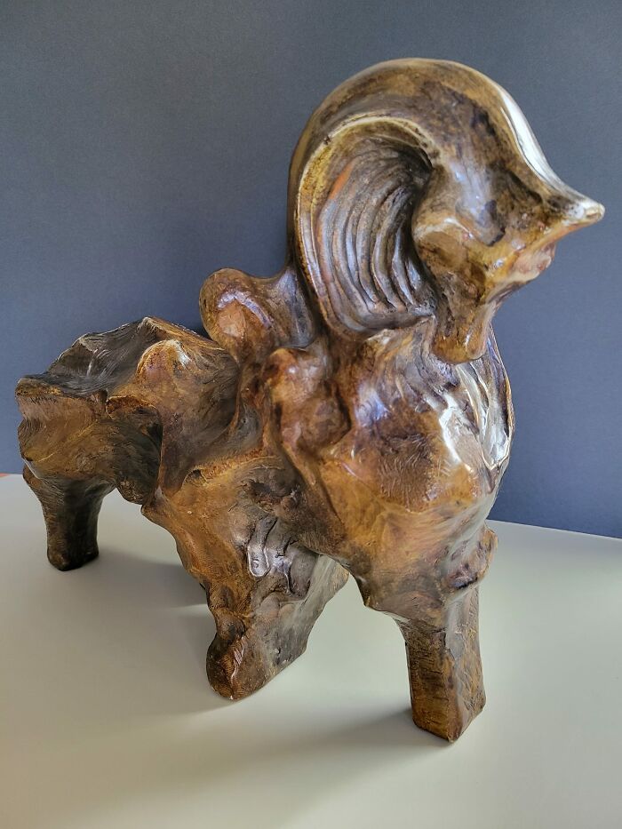 Wooden ram sculpture found at thrift stores, showcasing unique craftsmanship and natural wood grain details.