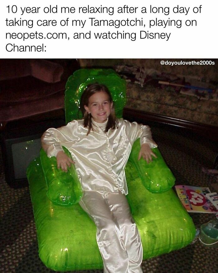 Child in satin pajamas relaxes on a green inflatable chair, embodying 2000s childhood nostalgia.