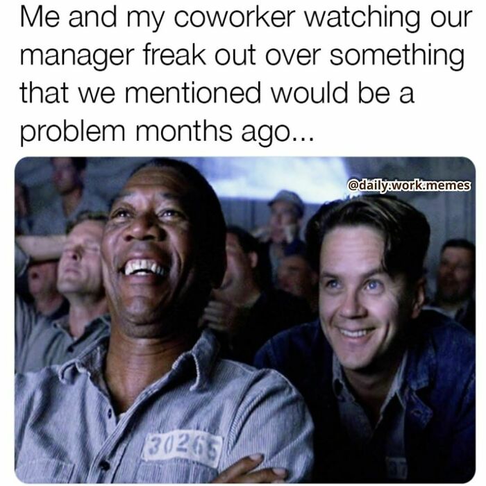 Two coworkers watching their manager freak out, sharing a funny and relatable moment to get through the work day.
