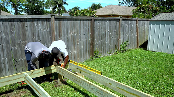 Workers checking blocks of floating deck.