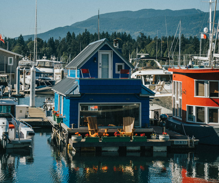 blue cottage houseboat on the water