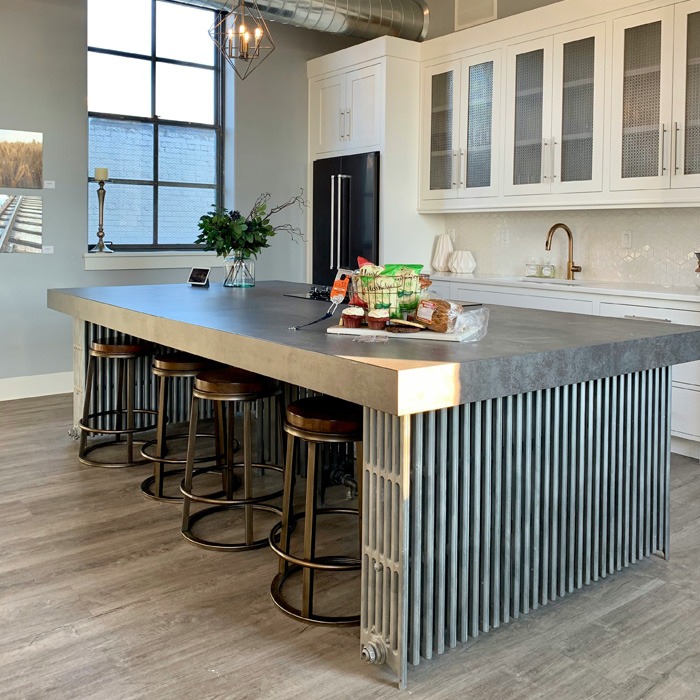 black industrial corian countertop on the grey kitchen cabinets