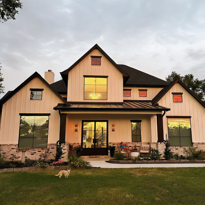White and black house with metal porch roof