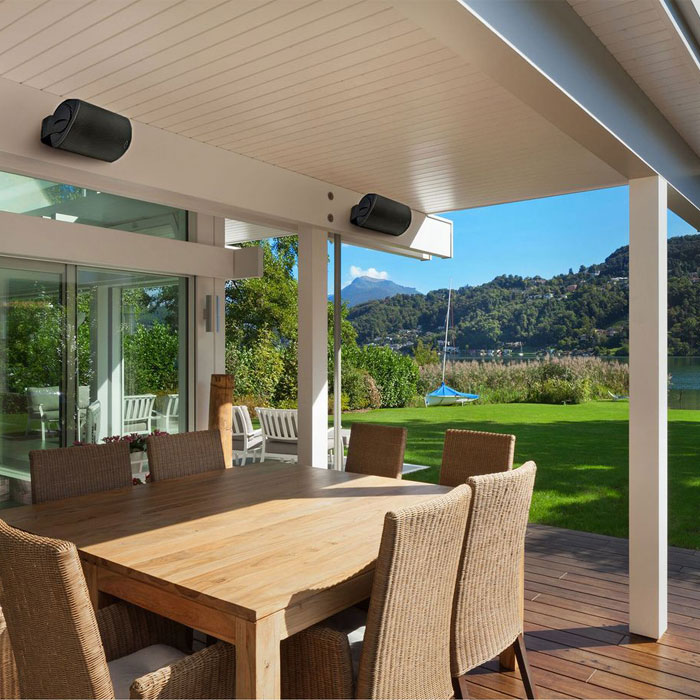 Porch with speakers and table with chairs