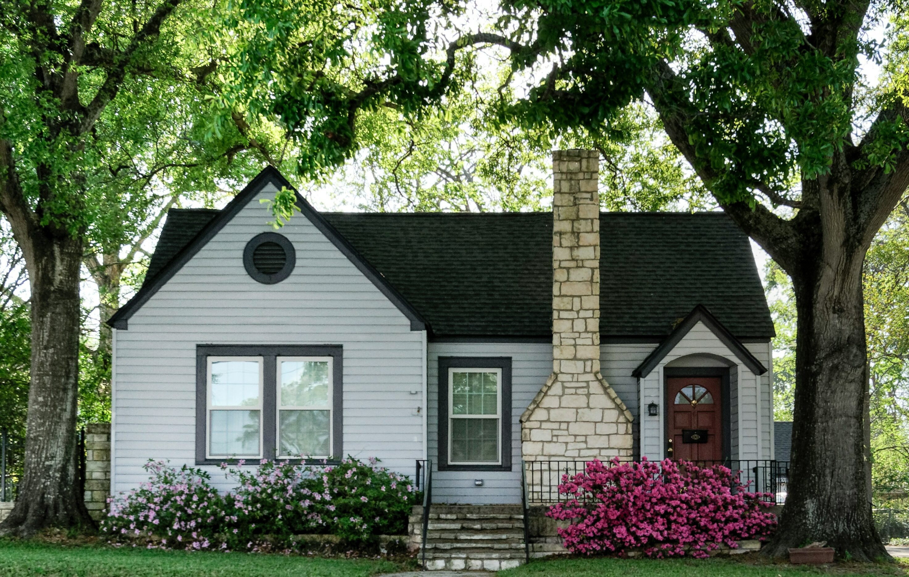 White house with flowers near entrance