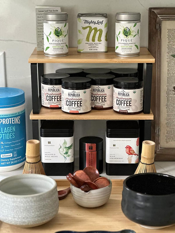 Small wooden shelf organizing tea containers, coffee jars, and utensils ideal for tiny apartment furniture finds.