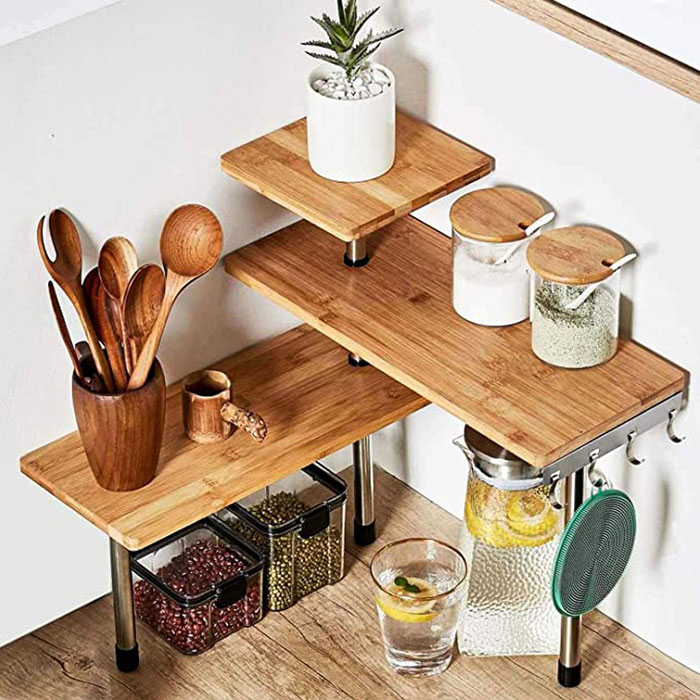 Compact wooden kitchen organizer for tiny apartment furniture with multiple shelves and hanging hooks for utensils.