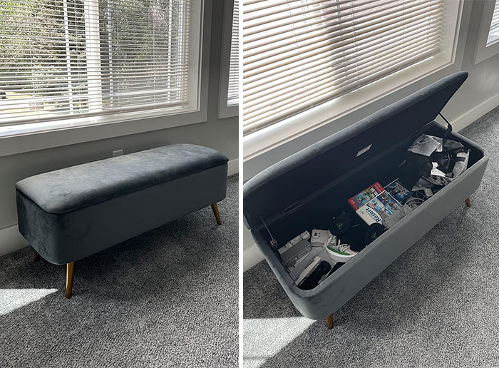 Blue velvet storage bench with wooden legs in a bright room, showcasing space-saving tiny apartment furniture design.