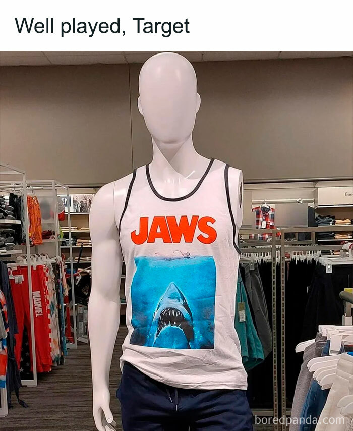 Mannequin in a store wearing a nostalgic 80s and 90s Jaws tank top, surrounded by casual clothing racks.